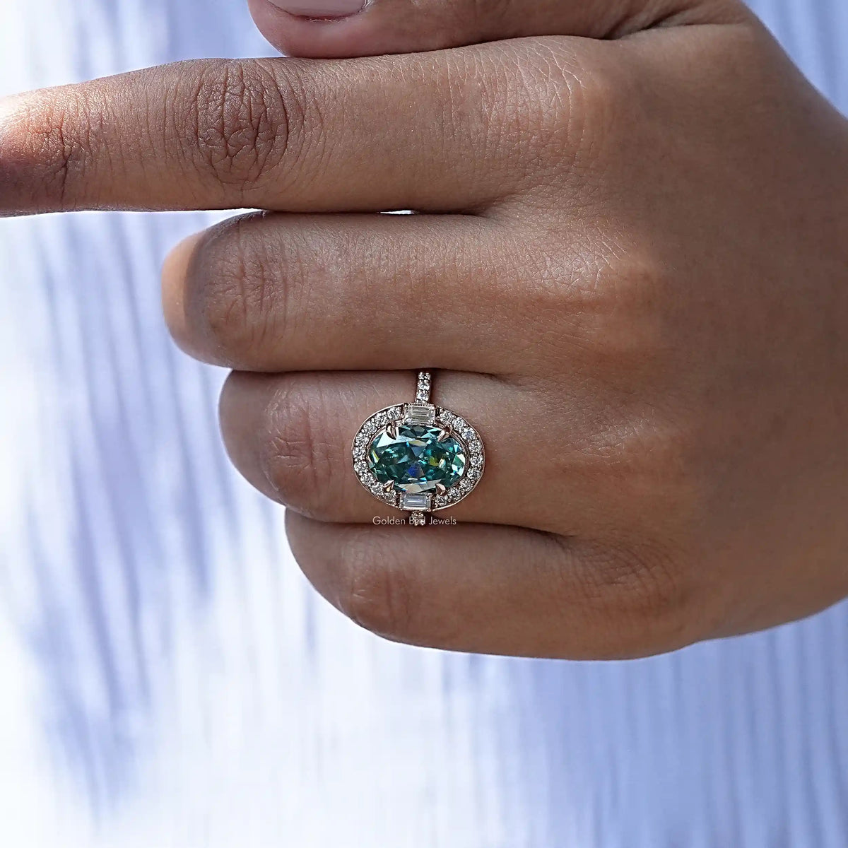 Detailed View Of Blue Oval Cut Halo Engagement Ring In Yellow Gold