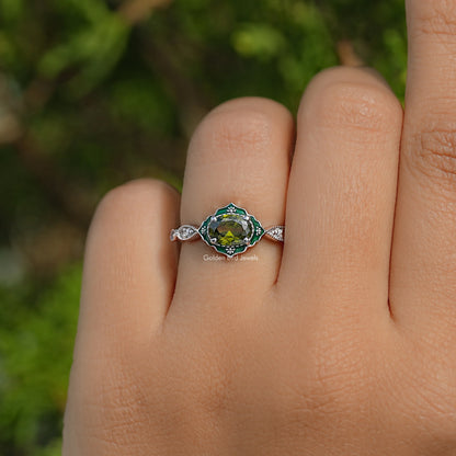 Oval green center gemstone with diamond halo engagement ring on open palm