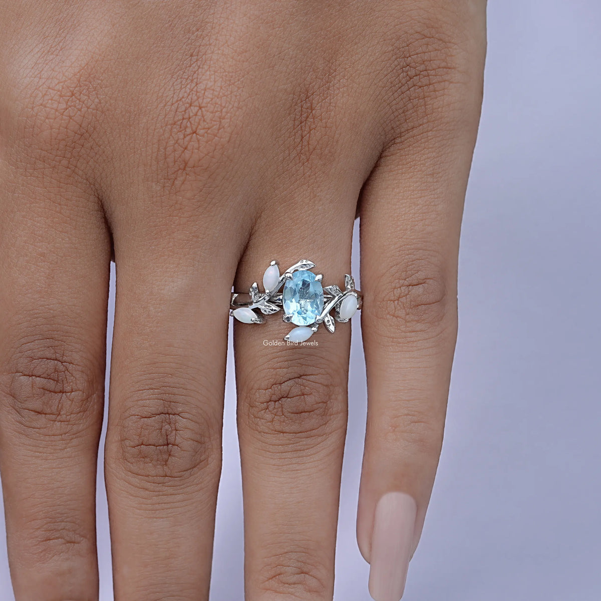 Close-Up View of Oval Cut Gemstone Leaf Style Accent Ring In White Gold