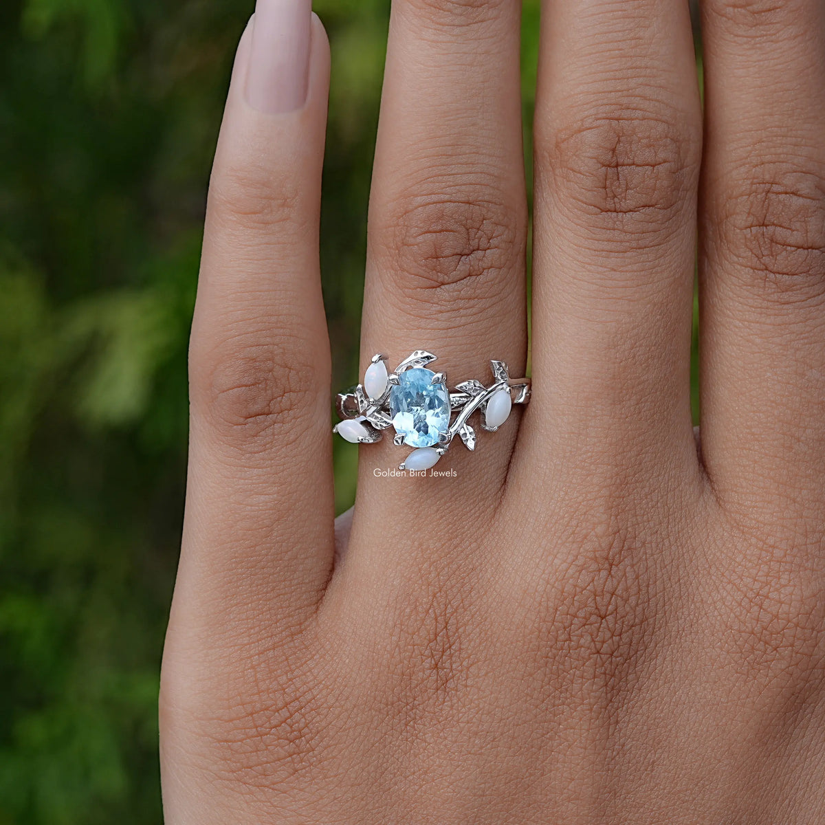 Detailed View Of Oval Cut Gemstone Leaf Style Accent Ring In Yellow Gold