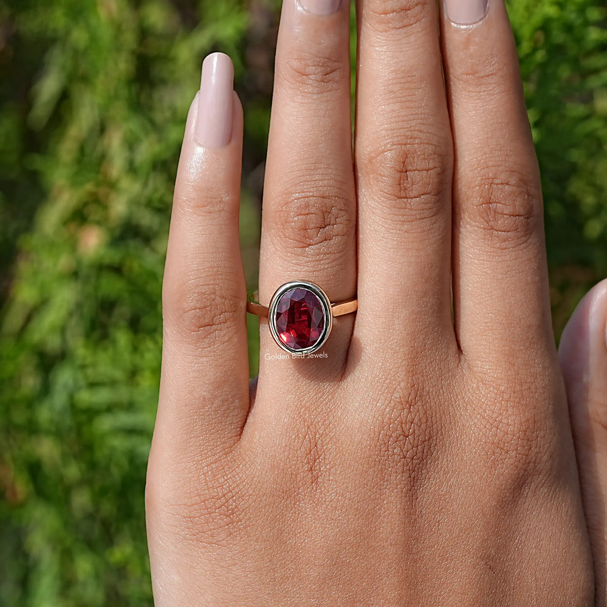 In finger view of Oval Cut Lab Gemstone Solitaire Ring