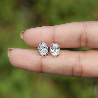 In Hand View Of Oval Cut Lab Diamond Bezel Studs