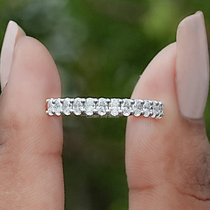 Sterling silver half-eternity ring band with oval moissanite stones, close-up