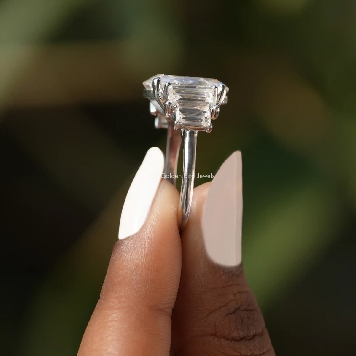 Side View of Moissanite Oval Cut Engagement Ring In two fingers