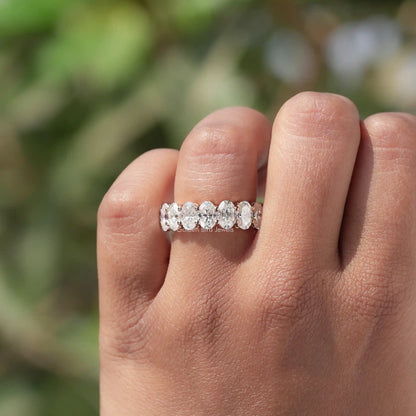 Oval-cut moissanite 3/4 eternity band ring on finger