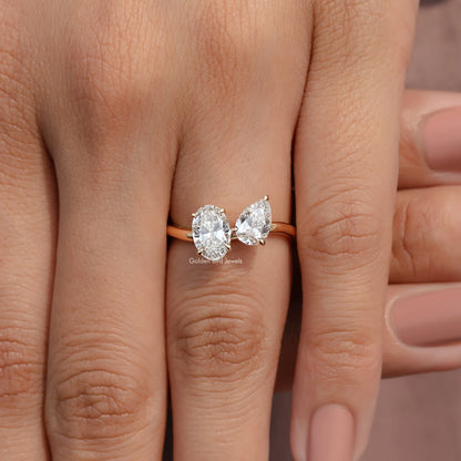 Gold toi et moi ring with two pear-cut lab diamonds, thin band, finger view