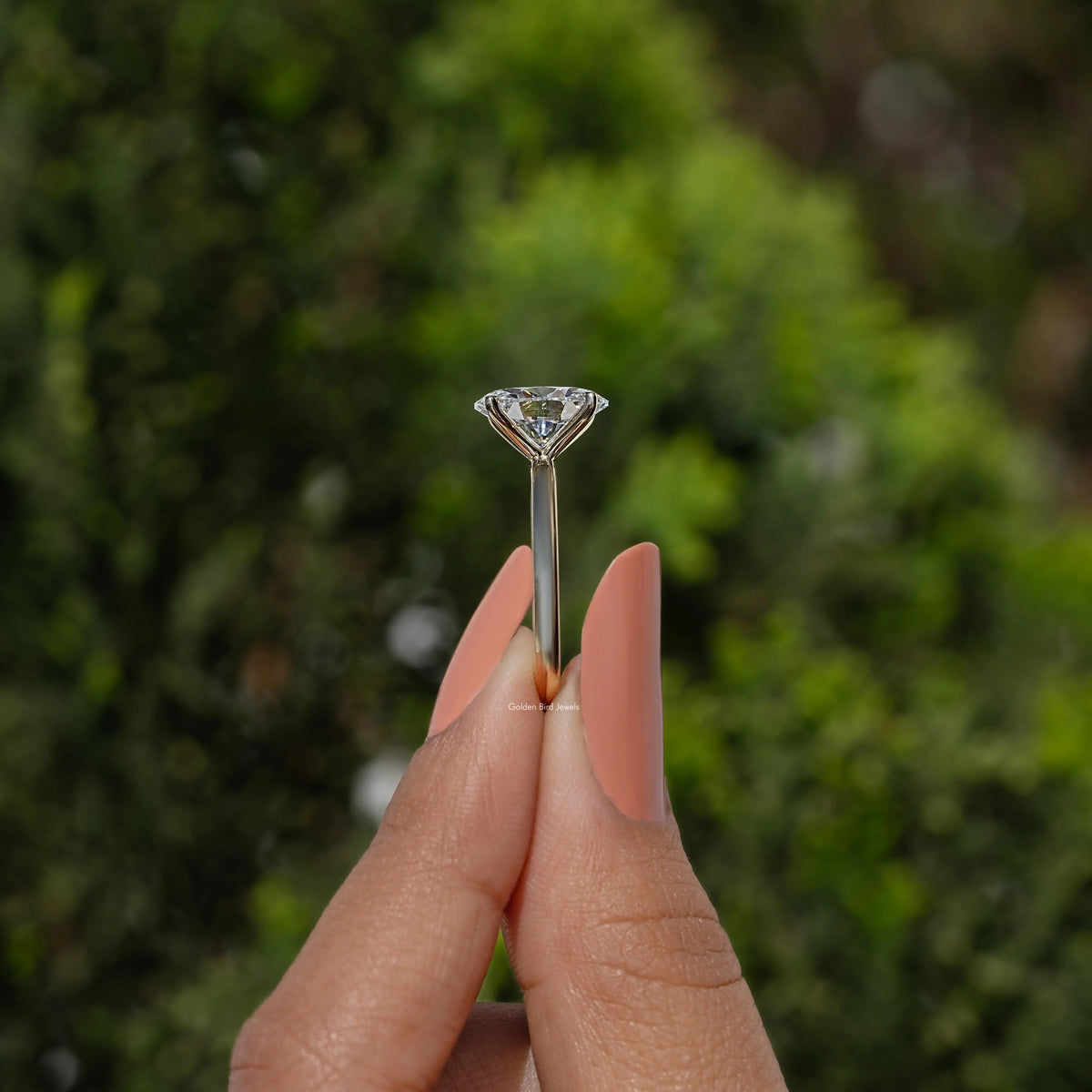 Oval lab diamond solitaire ring side view, showing thin band and four-prong setting