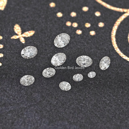 Loose oval-cut lab-grown diamond stones on dark display card, various sizes