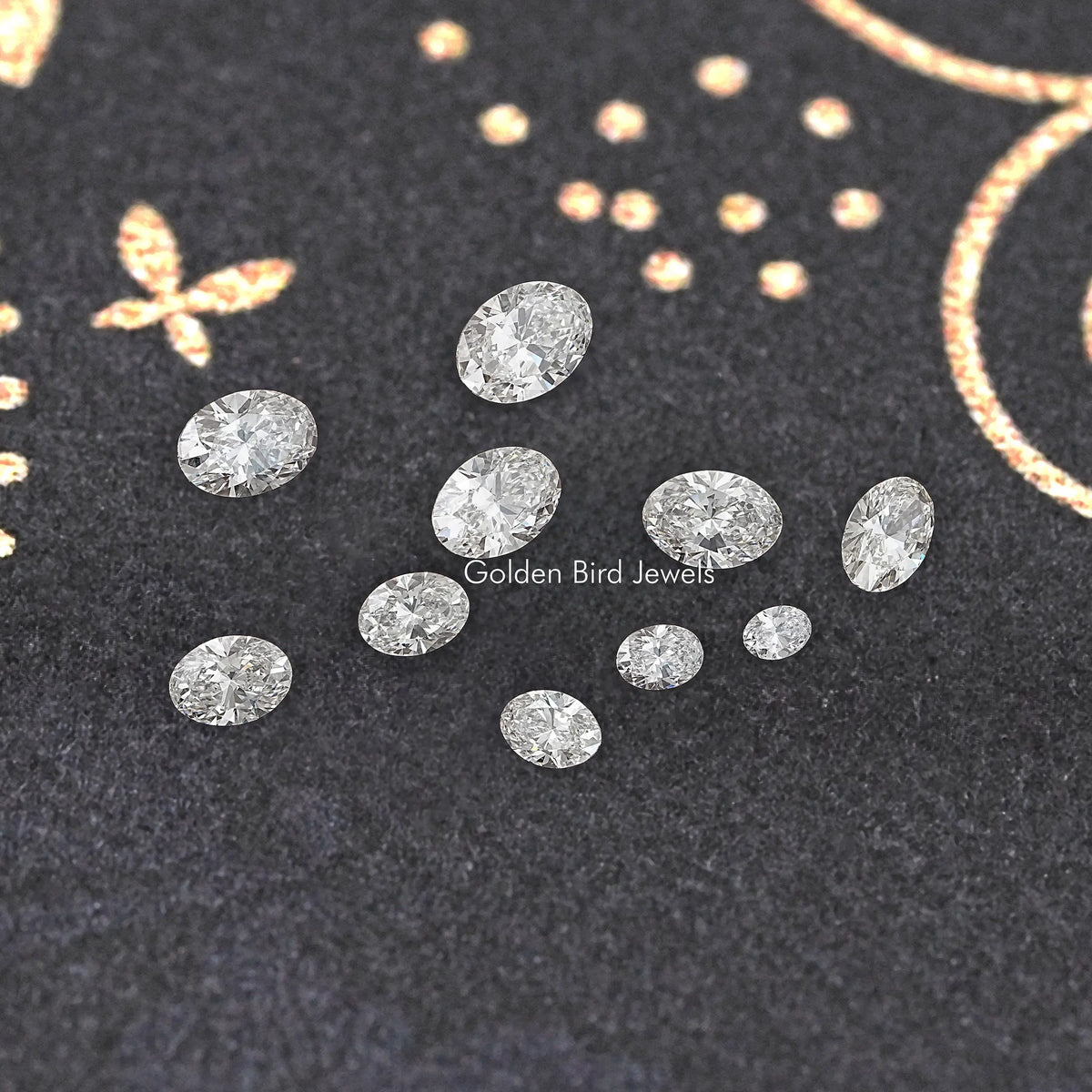 Set of loose oval lab diamonds, multiple stones on dark display