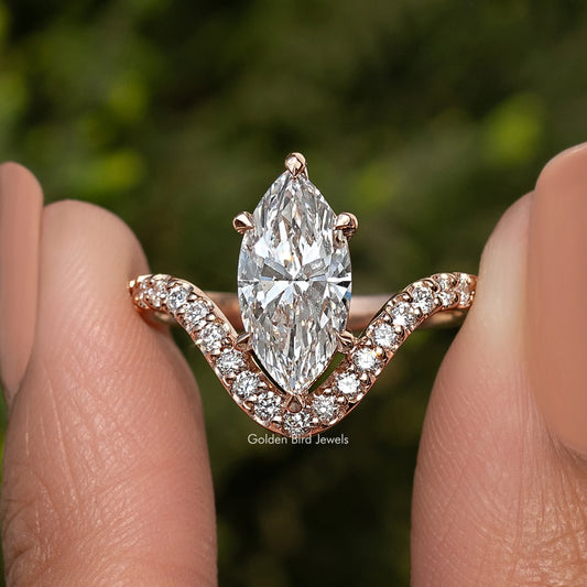 Gold-tone marquise-cut diamond ring with curved three-stone side accents