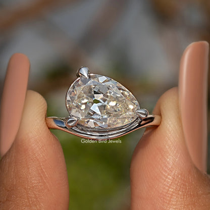 Pear-cut moissanite solitaire ring in sterling silver with open setting and prongs