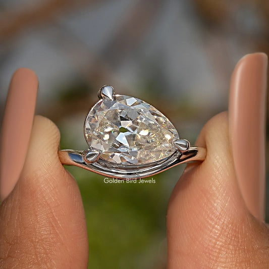 Pear-cut moissanite solitaire ring in sterling silver with open setting and prongs