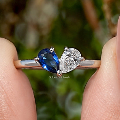Toi moi engagement ring with blue oval gemstone and round diamond on silver band