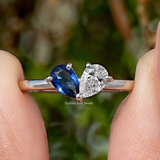 Toi moi engagement ring with blue oval gemstone and round diamond on silver band