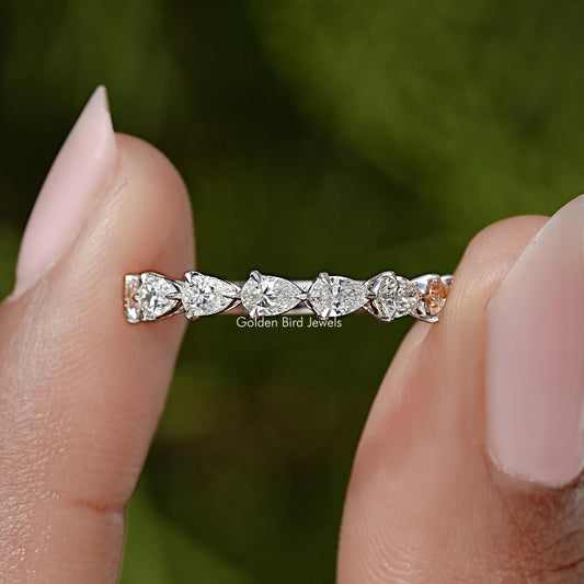 Pear-cut diamond eternity band with prong-set stones on a slim silver ring