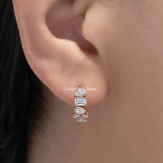 Gold-tone huggie hoop earrings with multi-shaped lab diamonds, front close-up