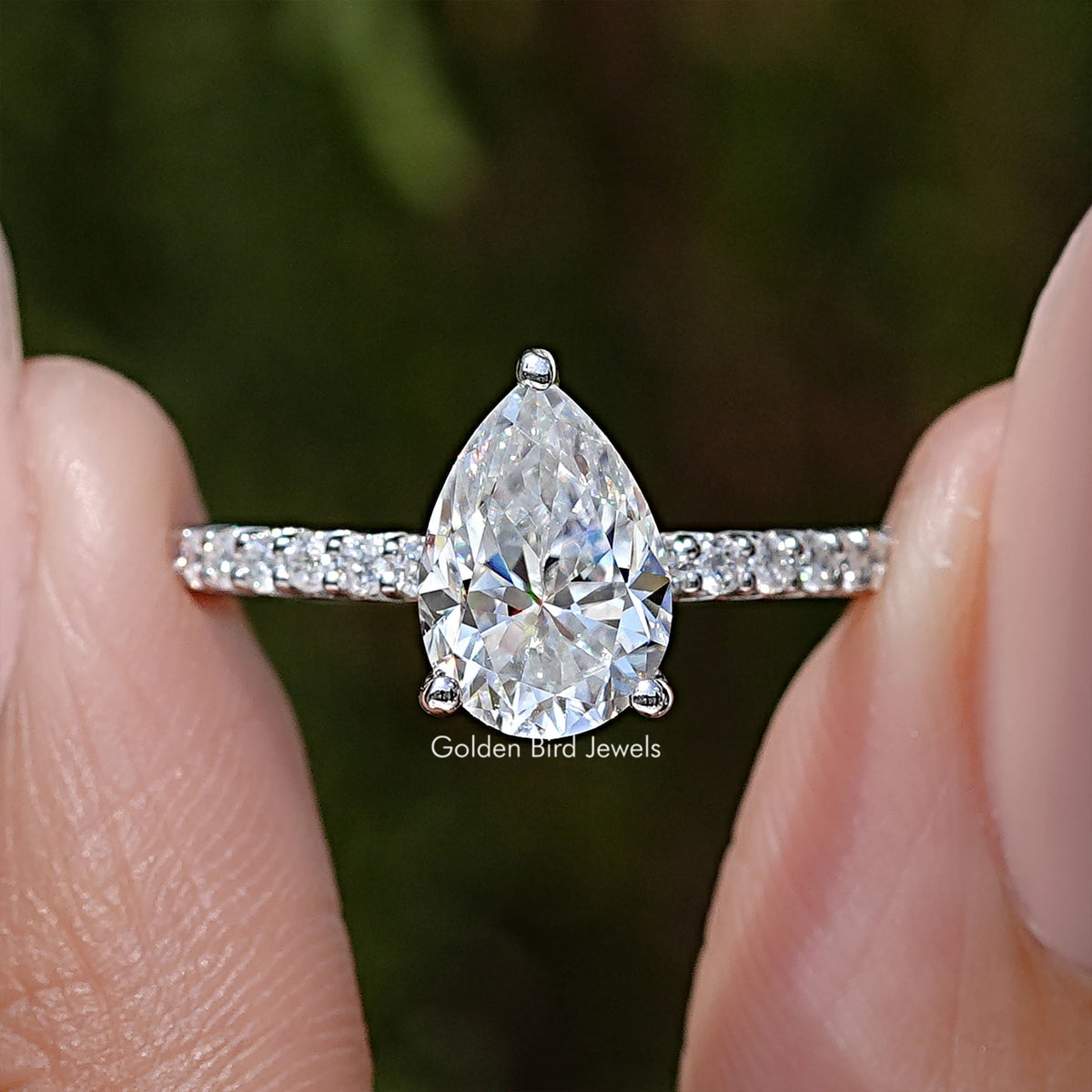 Sterling silver pear-cut solitaire moissanite ring with two-row side accent stones
