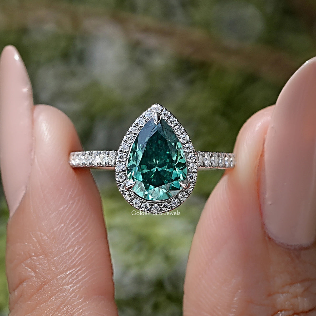 Pear-cut green moissanite halo ring with pavé band in sterling silver
