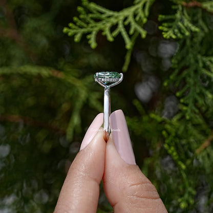 Pear-cut moissanite engagement ring with tall prong setting, green center stone