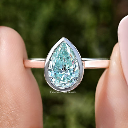Sterling silver bezel-set solitaire ring with pear-cut light blue moissanite