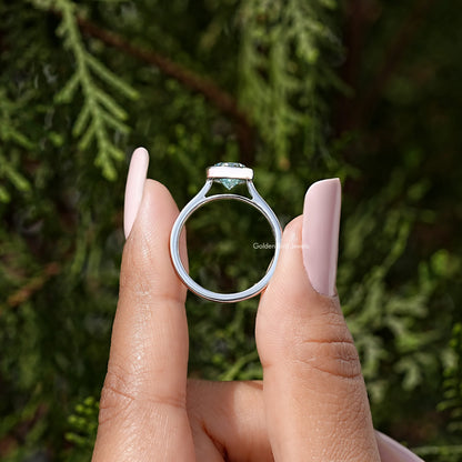 Sterling silver bezel-set solitaire ring open-angle view, pear-cut moissanite