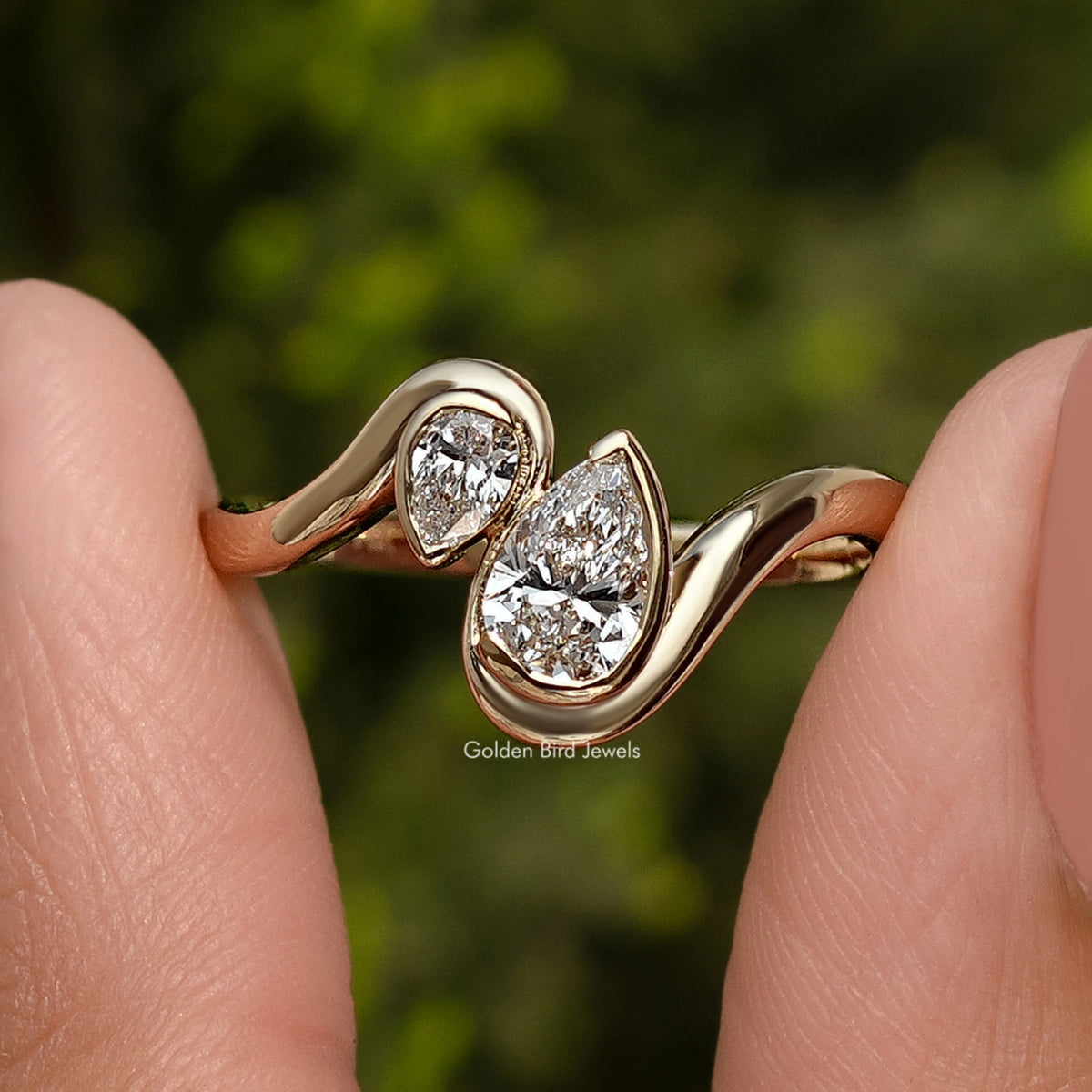 Close-up rose gold toi et moi ring with two pear-cut lab diamonds and prongs