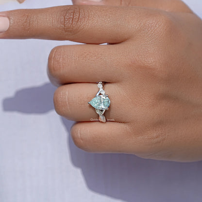 925 sterling silver ring with pear-cut blue moissanite center stone, floral tips