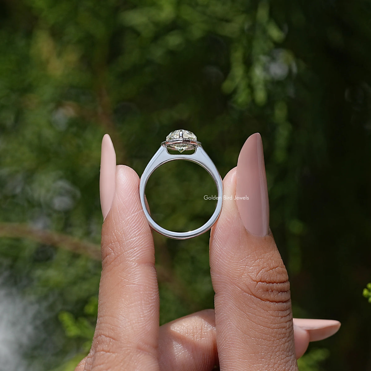 Pear-cut moissanite halo engagement ring back view, open band with top halo