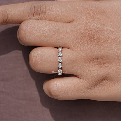 Pear-cut diamond eternity ring detail, prong-set stones across a slim silver band