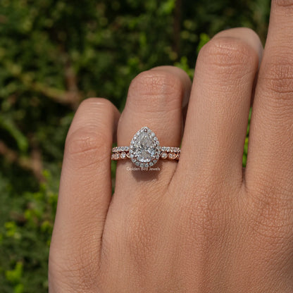Pear-cut moissanite halo bridal ring set on finger