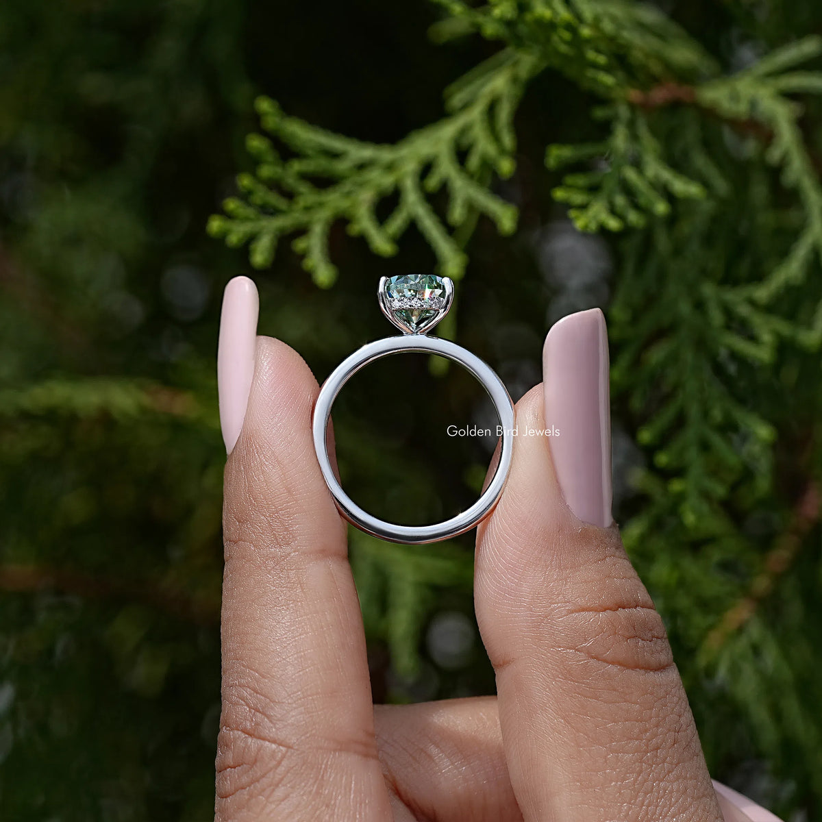 Sterling silver pear-cut moissanite engagement ring, top view of band and prongs