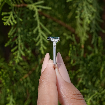 Sterling silver engagement ring with green pear-cut moissanite and diamond halo