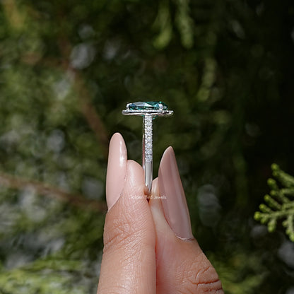 Sterling silver ring top view: green pear moissanite with halo and prong set band