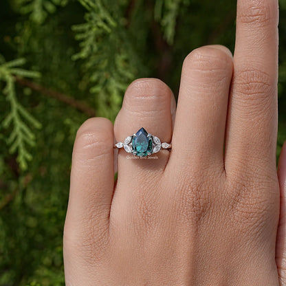 Green pear-cut moissanite engagement ring with round halo stones and side accents