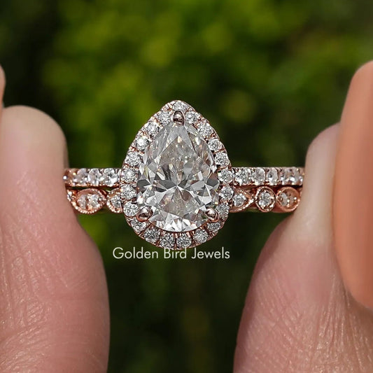 Pear-shaped moissanite halo bridal set with pavé band and matching accent ring