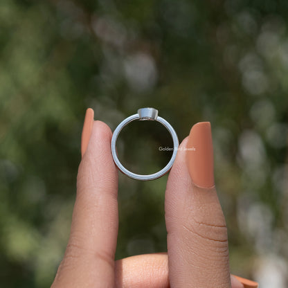 Silver solitaire ring, plain band with bezel-set diamond setting, back view