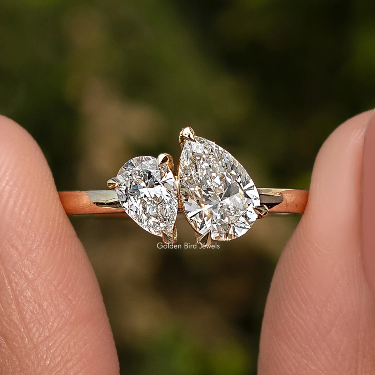 Gold pear-shaped two-stone lab diamond ring with slim band, two prong-set stones.