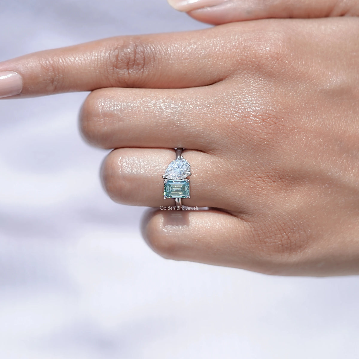 View of Pear And Emerald cut Moissanite Ring in prongs setting 