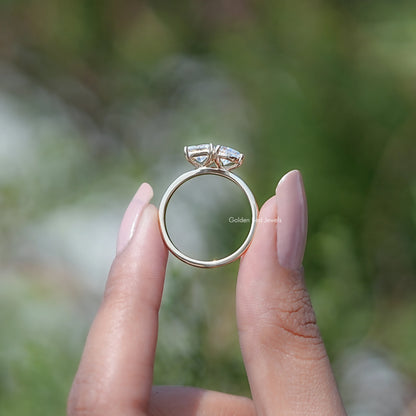 Moissanite toi et moi ring showing round band and pear and princess-cut stones