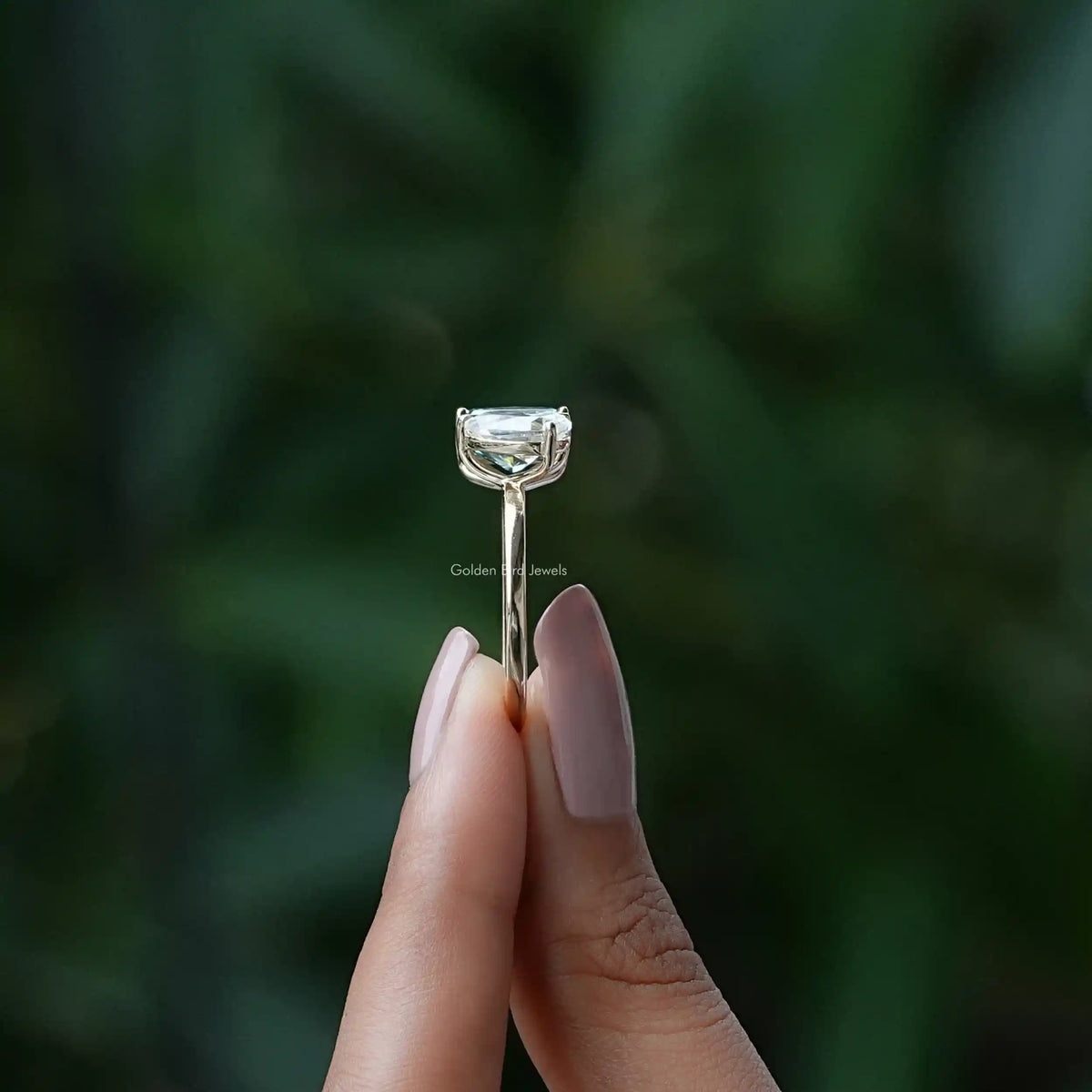 Silver ring with a clear pear-cut gemstone in an open prong setting