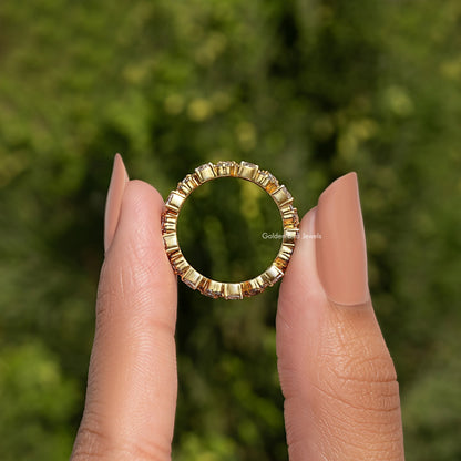 Open view of gold-tone moissanite eternity band with small round stones
