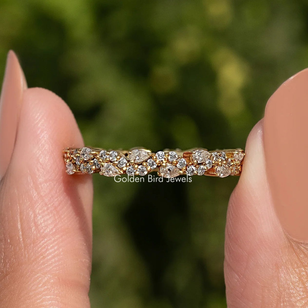 Moissanite eternity band ring with round and pear stones, gold-tone setting