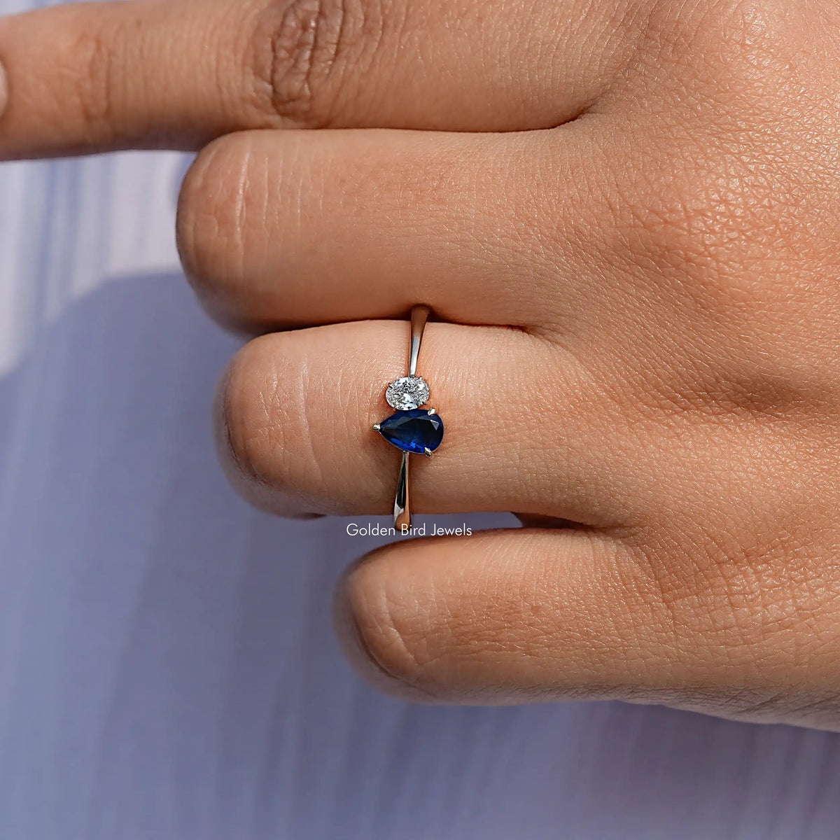 Close View Of Blue Pear Cut Halo Engagement Ring
