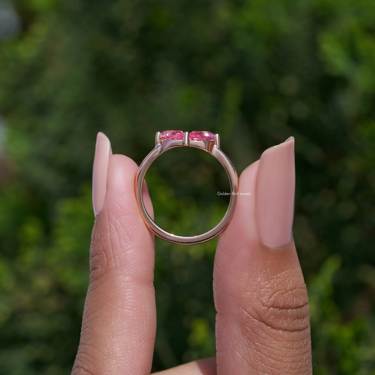Toi et moi ring with two pink pear-cut lab gemstones, prong set on slim band