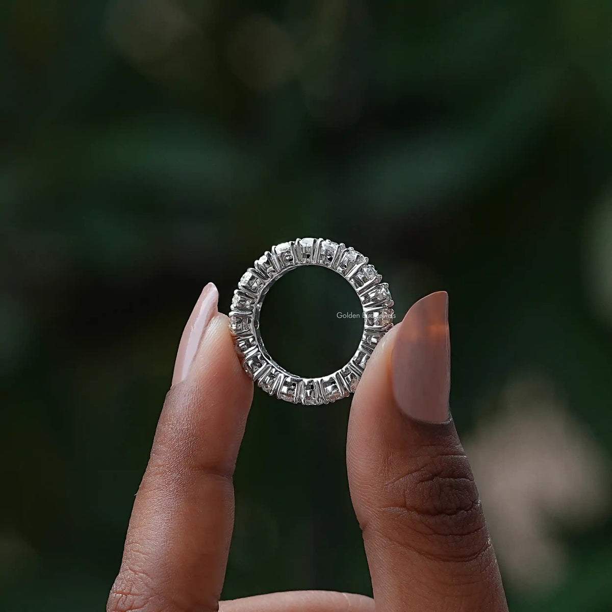 Silver moissanite eternity band ring with prong-set sparkling stones, front view