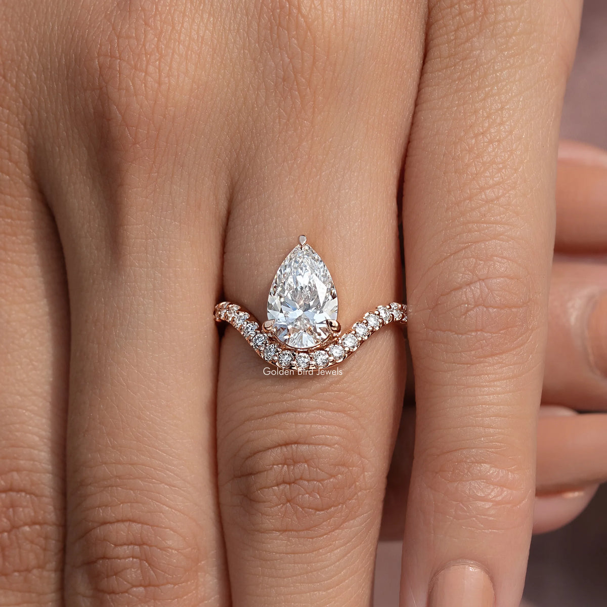 Pear-cut lab-grown diamond engagement ring with curved accent band