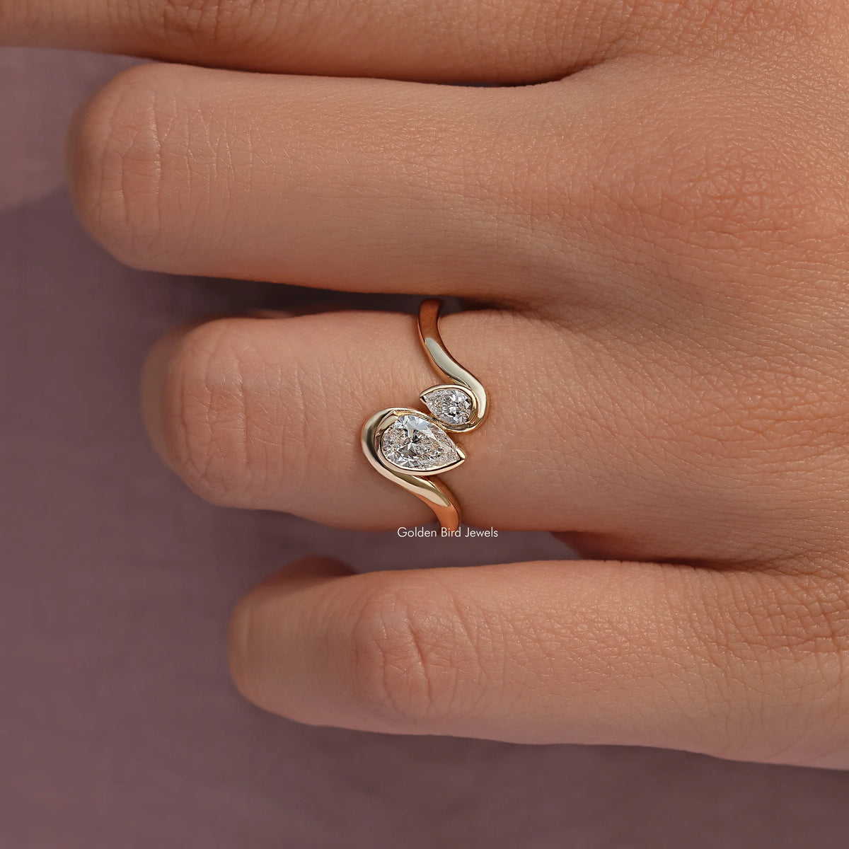 Rose gold toi et moi ring with two pear-cut lab diamonds, curved setting