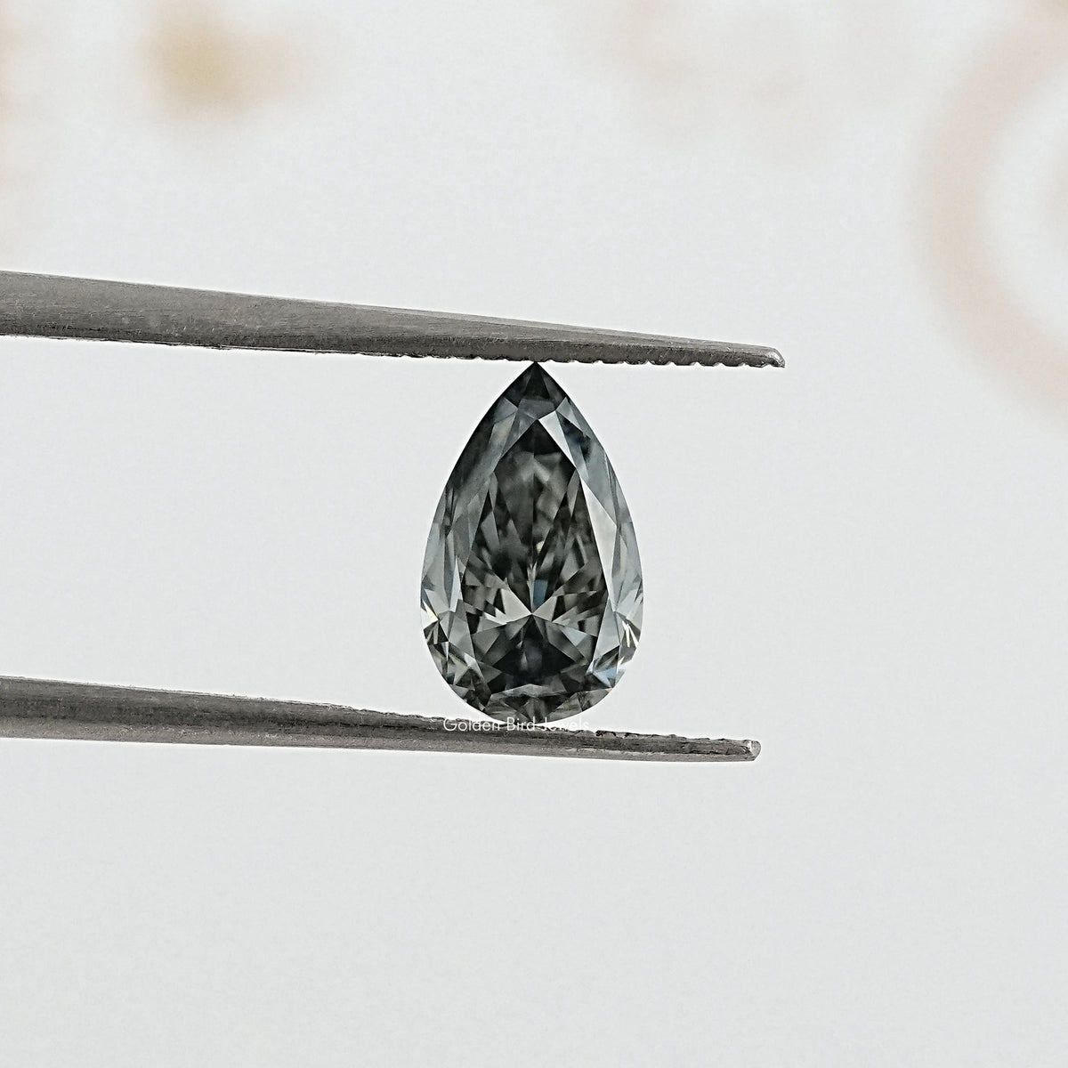 tweezers  View of Dazzling Gray Pear Cut Moissanite for Anniversary Rings