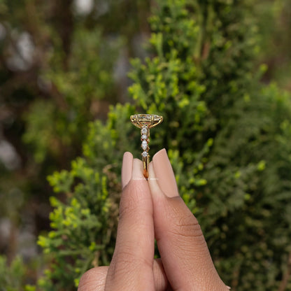 Pear-cut moissanite engagement ring with three-stone accent band