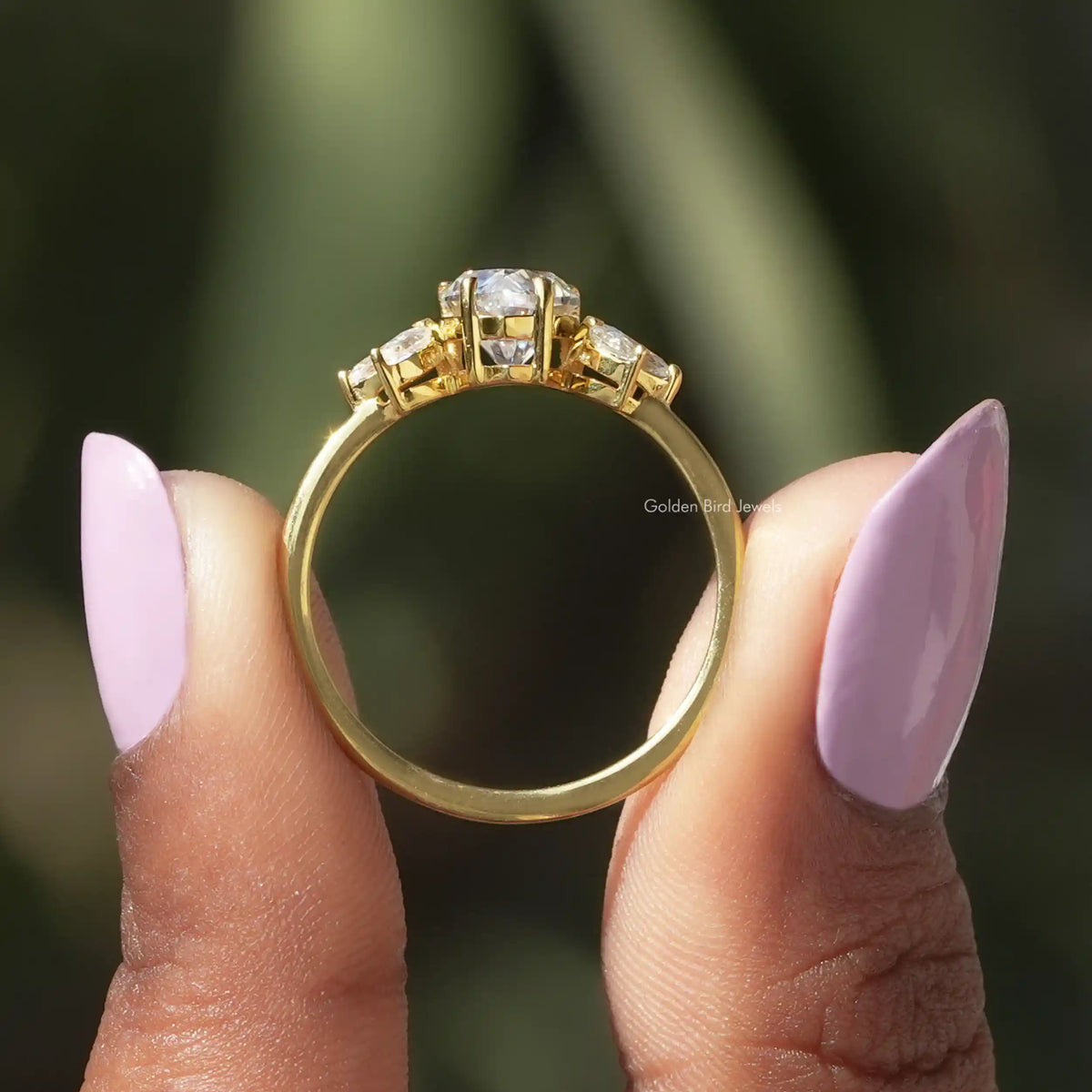 Back View of Pear Cut Moissanite Engagement Ring In two fingers